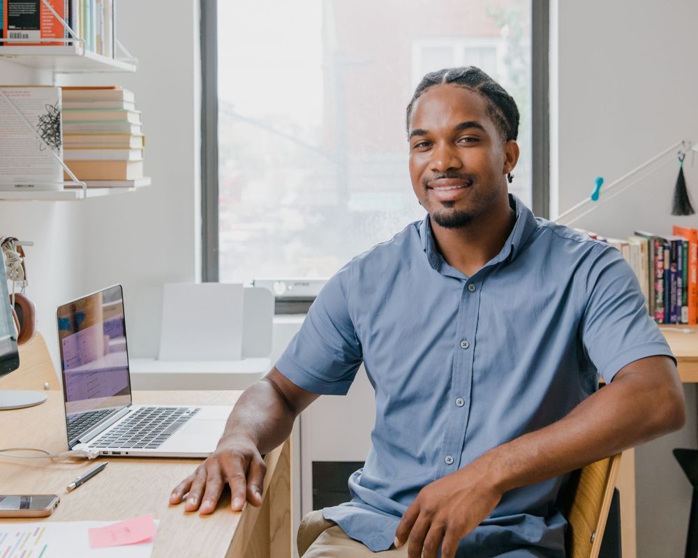 Smiling man sitting at his desk in an office